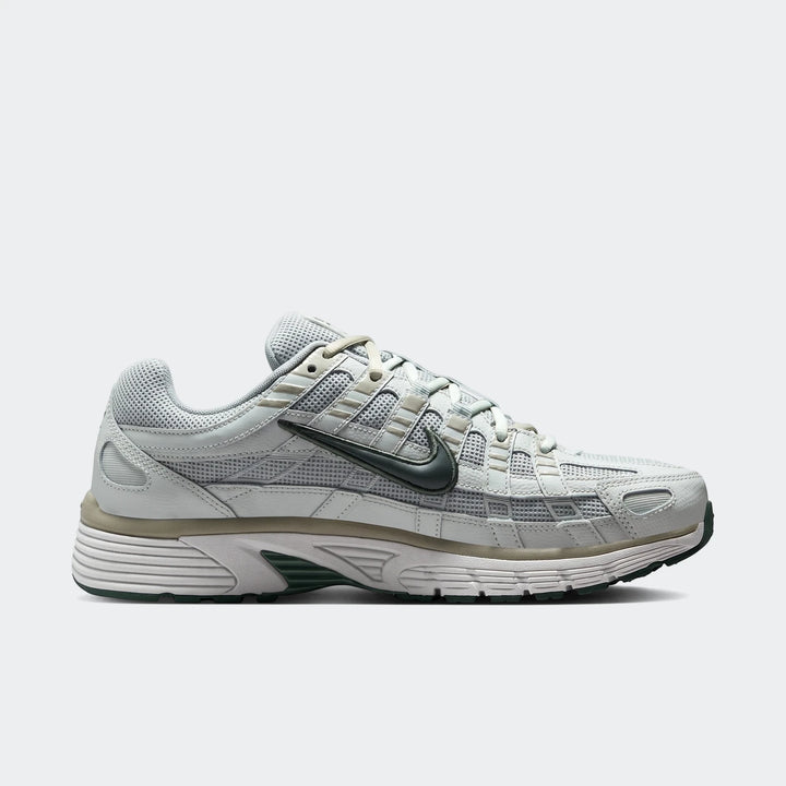 Light grey Nike P-6000 Men's Shoes with dark grey swoosh, featuring mesh and leather overlays, viewed from the side on a