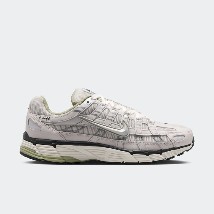 Nike P-6000 Men's Shoes in off-white and light green with a metallic silver swoosh, shown from a side view.