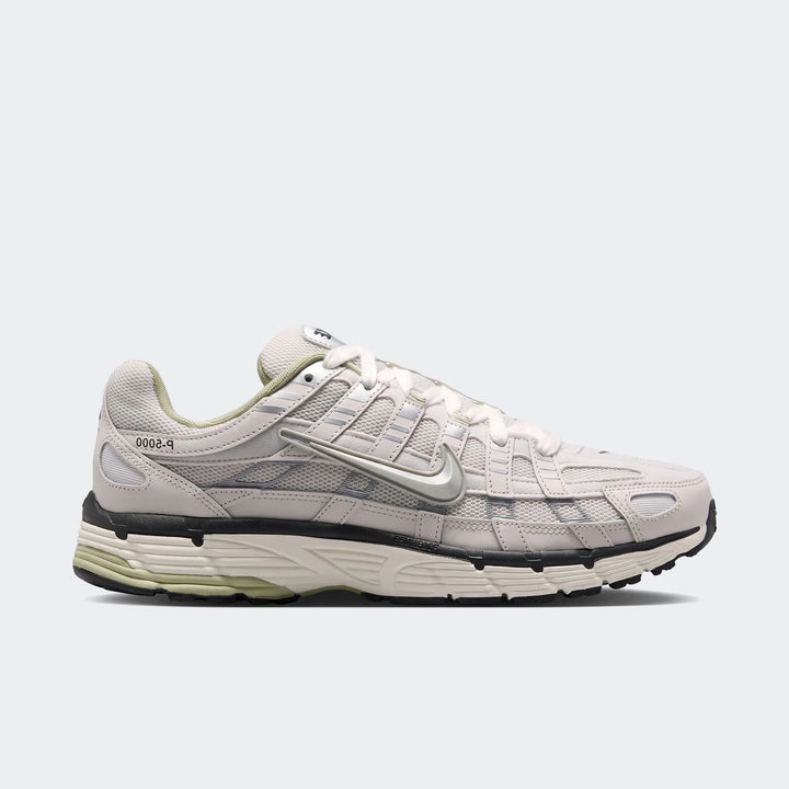 White and silver Nike P-6000 men's running shoe with mesh and leather overlays, shown from a side view.