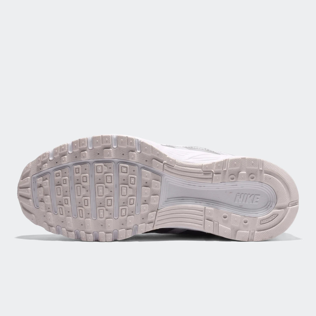 Sole view of a white Nike P-6000 running sneaker, showcasing the intricate tread pattern and brand logo.