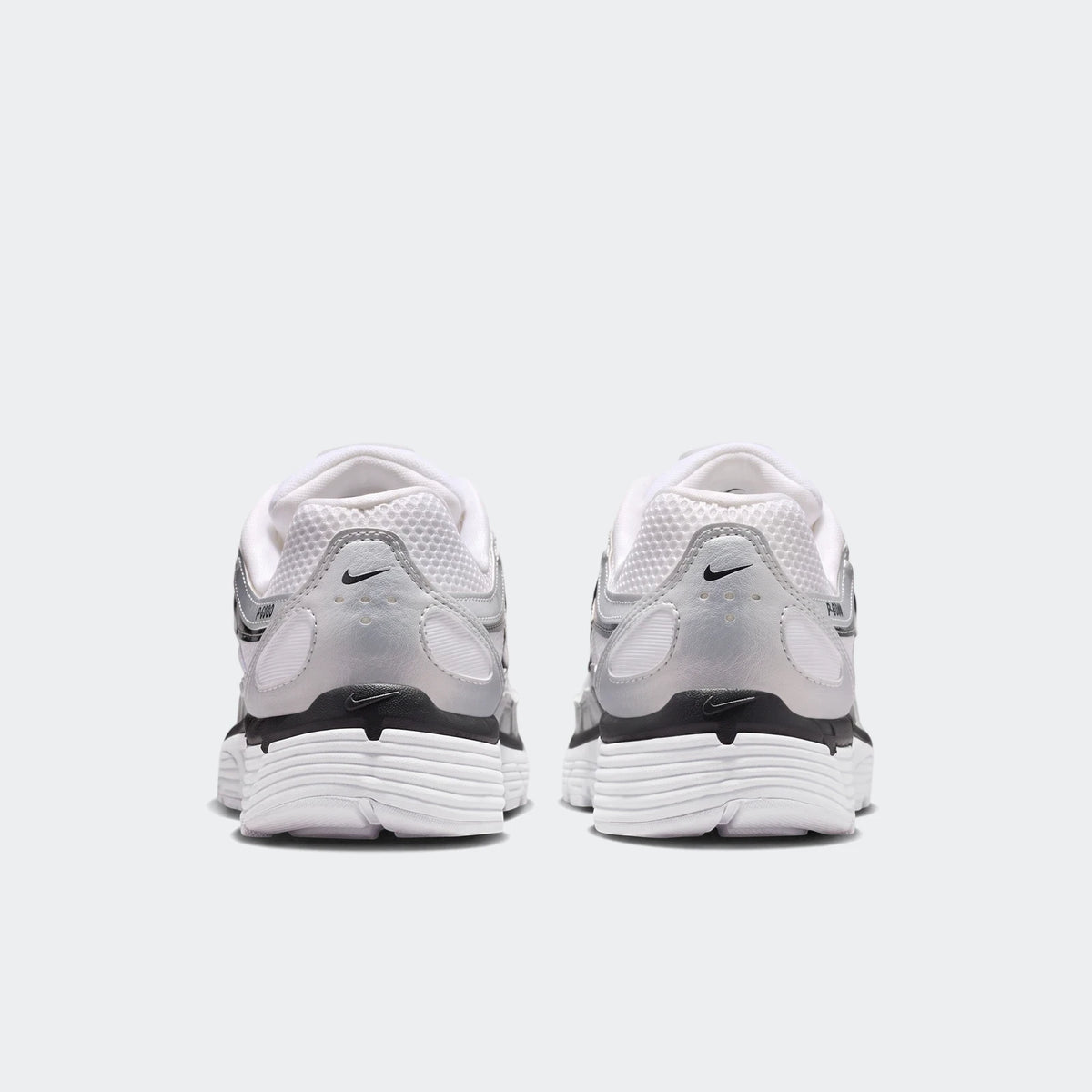 Rear view of Nike P-6000 Women's Shoes in white, silver, and black, featuring mesh and synthetic leather panels.