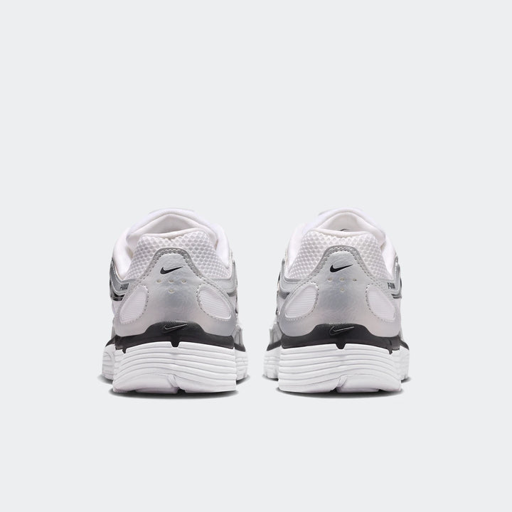 Rear view of Nike P-6000 Women's Shoes in white, silver, and black, featuring mesh and synthetic leather panels.