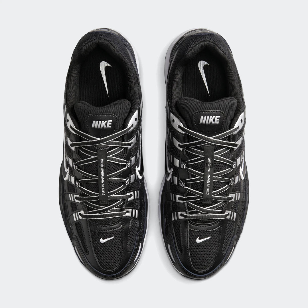 Top-down view of black Nike P-6000 shoes with white laces and silver accents, ideal for running and casual wear.