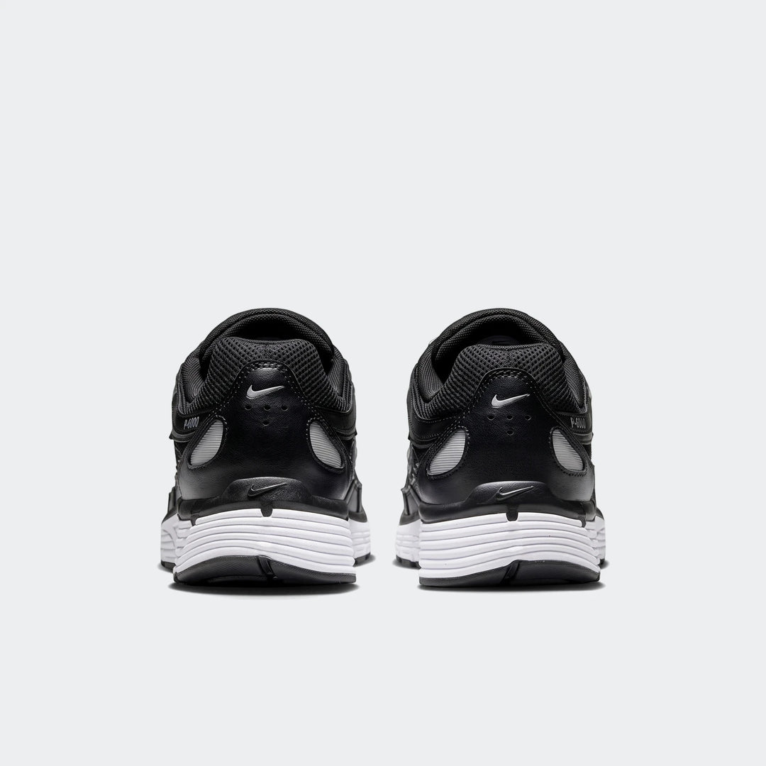 Rear view of Nike P-6000 athletic shoes in black with white soles, showcasing the classic design.