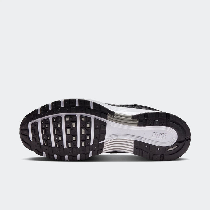 Nike P-6000 running shoe sole in black and white, featuring a black rubber outsole with detailed tread patterns and a white