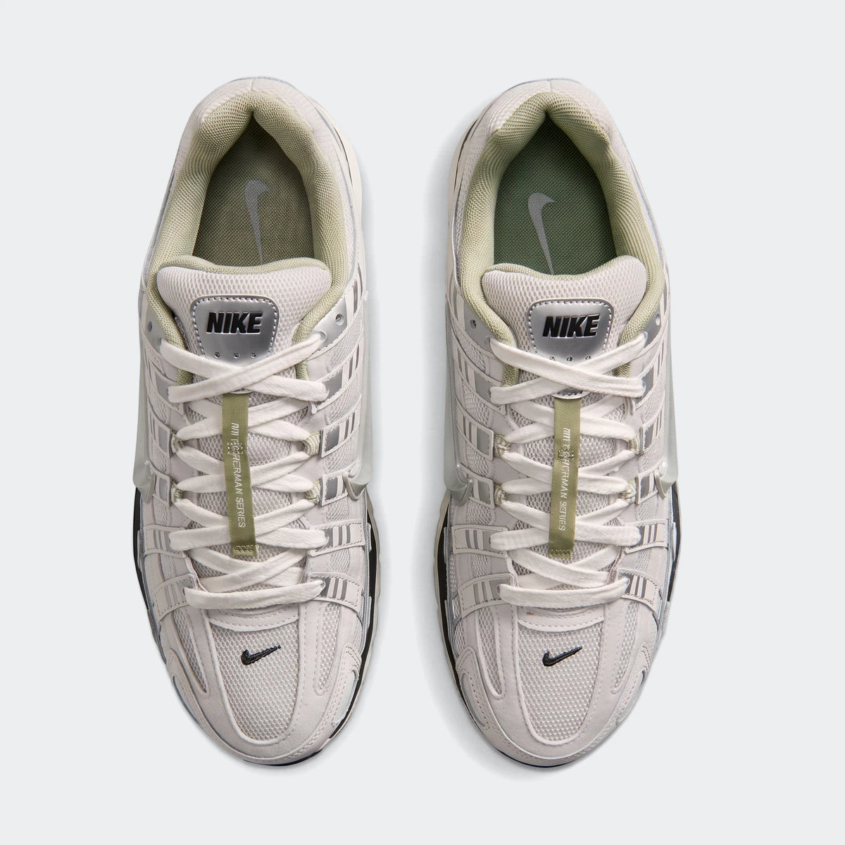 Top-down view of two Nike P-6000 Men's Shoes in light gray and off-white with green accents, perfect for athletic wear.