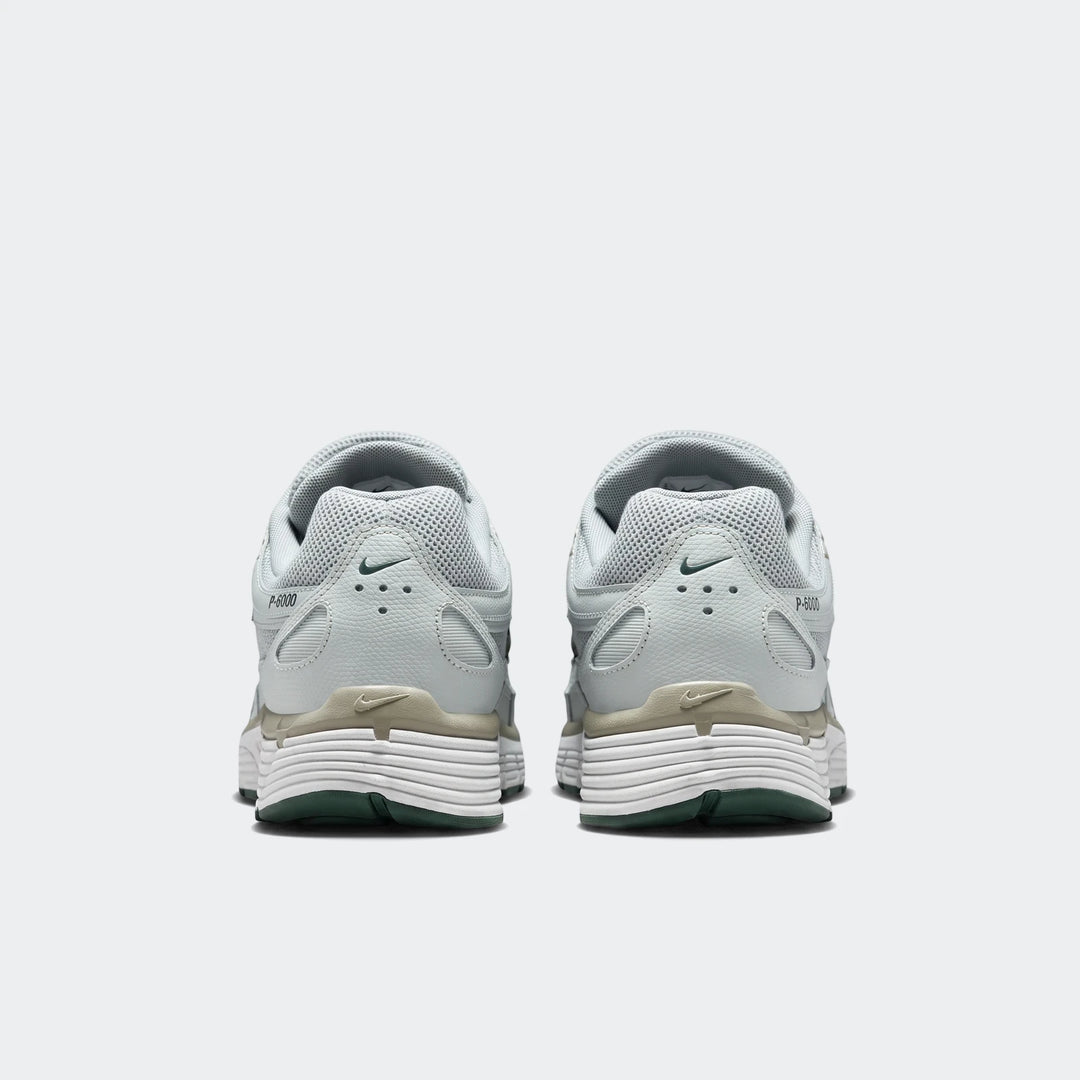 Rear view of Nike P-6000 Men's Shoes in light green with white ridged midsoles and dark green outsoles.