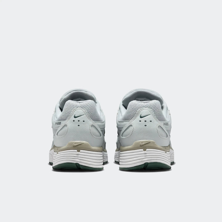 Rear view of Nike P-6000 Men's Shoes in light green with white ridged midsoles and dark green outsoles.