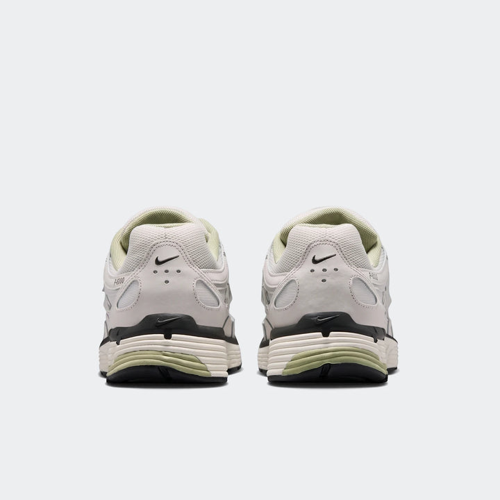 Rear view of Nike P-6000 men's shoes in light grey with black and subtle light green accents, showcasing the layered sole