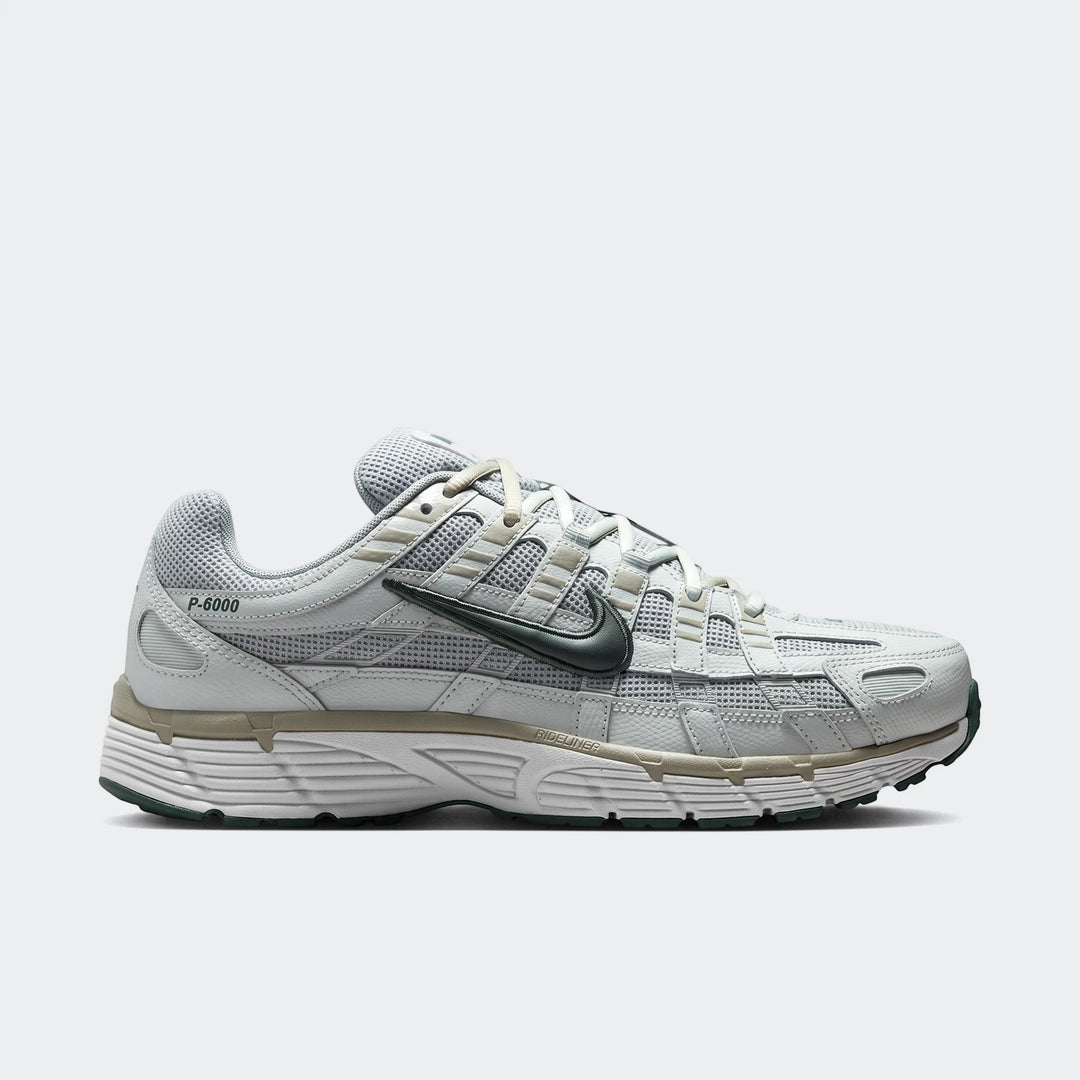 Nike P-6000 Men's Shoes in light grey and dark green, featuring a mesh upper and white sole, viewed from the side.