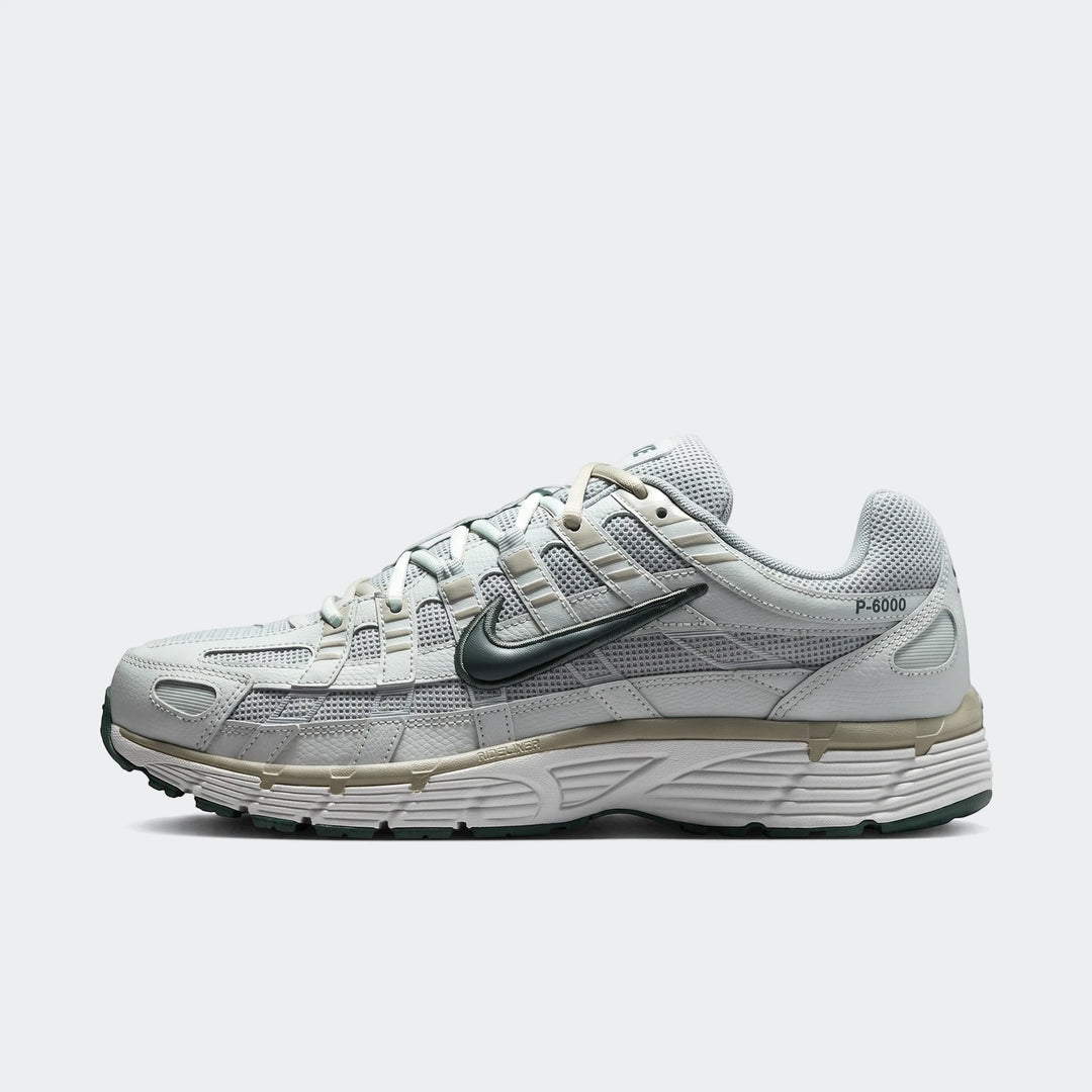 Nike P-6000 Men's Shoes in light grey with dark green accents, featuring a mesh and synthetic upper, shown from a side view.