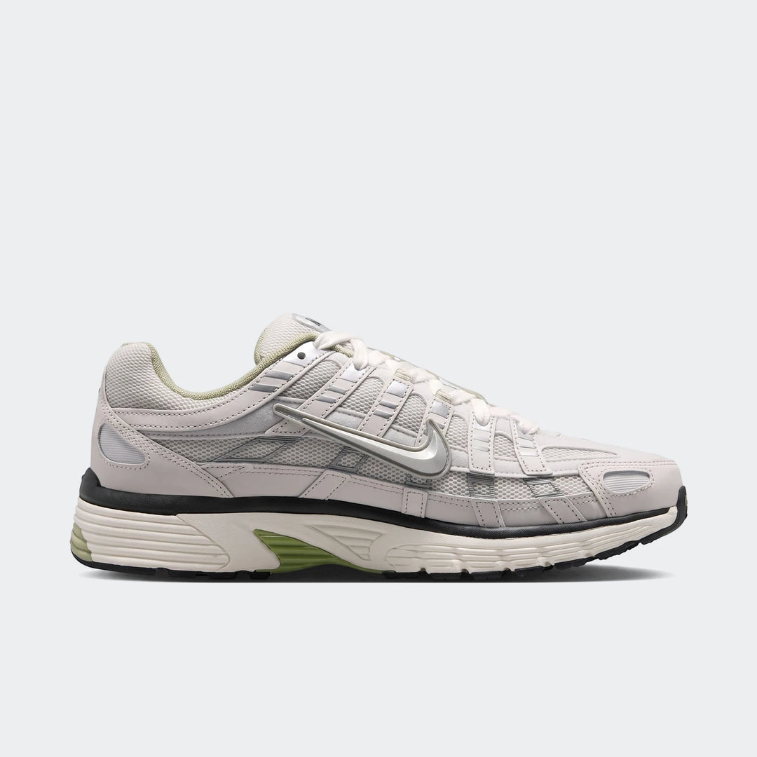 Nike P-6000 Men's Shoes in light grey and silver mesh, featuring a metallic swoosh and green accents, presented from a side