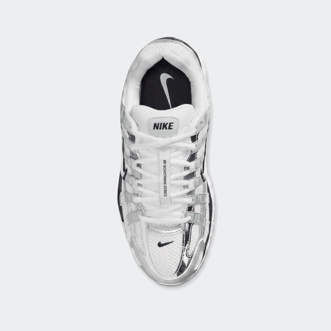 Top-down view of white and silver Nike P-6000 Women's athletic shoes with mesh and metallic overlays.