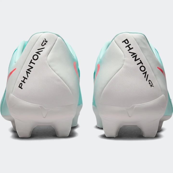 Rear view of two Nike Phantom Gx 11 Academy Fg/Mg green soccer cleats with white heels and coral accents.