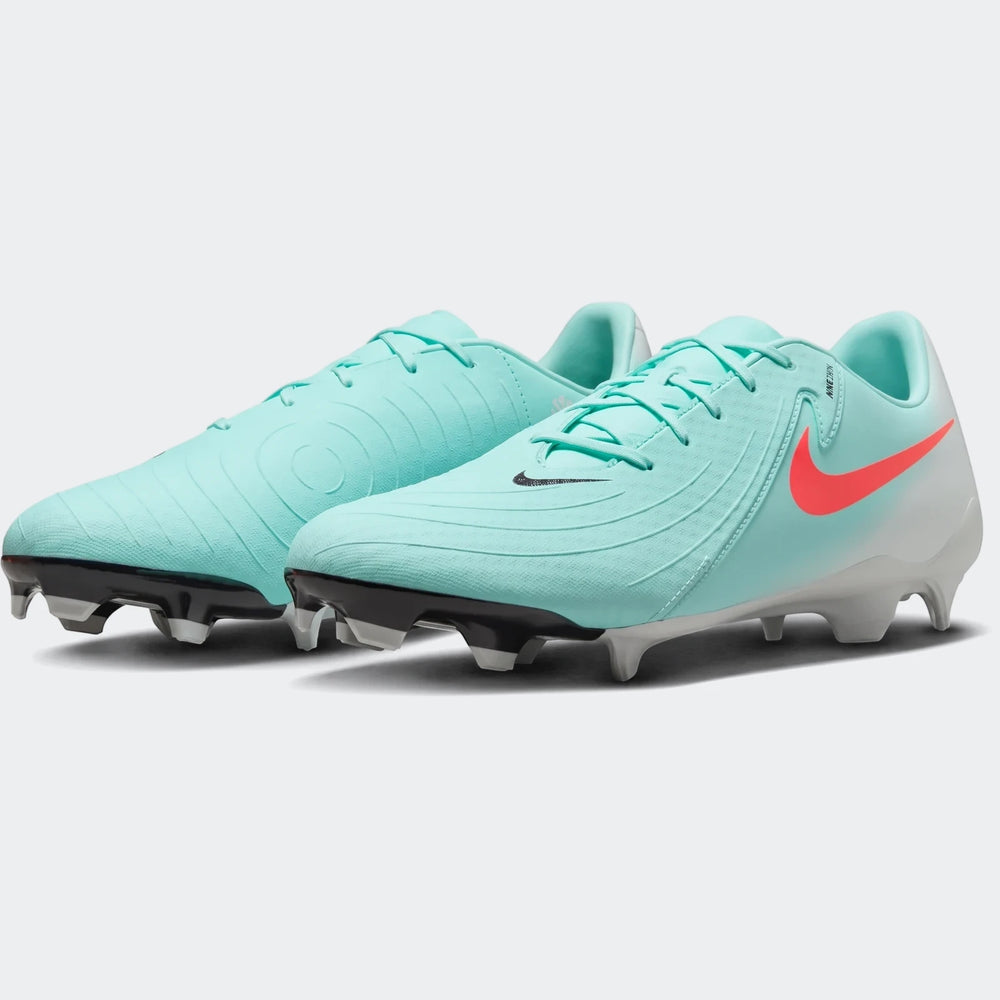 Pair of aqua green Nike Phantom Gx 11 Academy Fg/Mg soccer cleats with coral swooshes, shown on a white background.