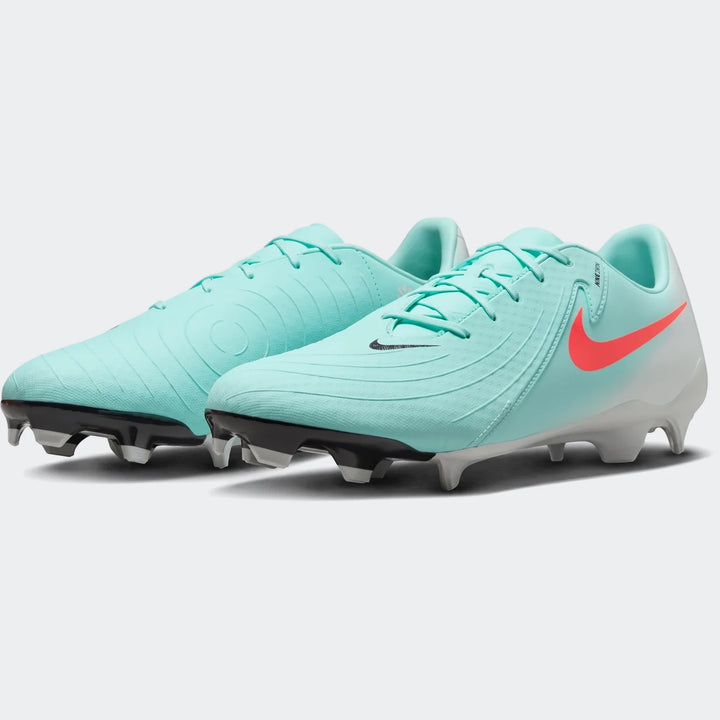 Pair of aqua green Nike Phantom Gx 11 Academy Fg/Mg soccer cleats with coral swooshes, shown on a white background.