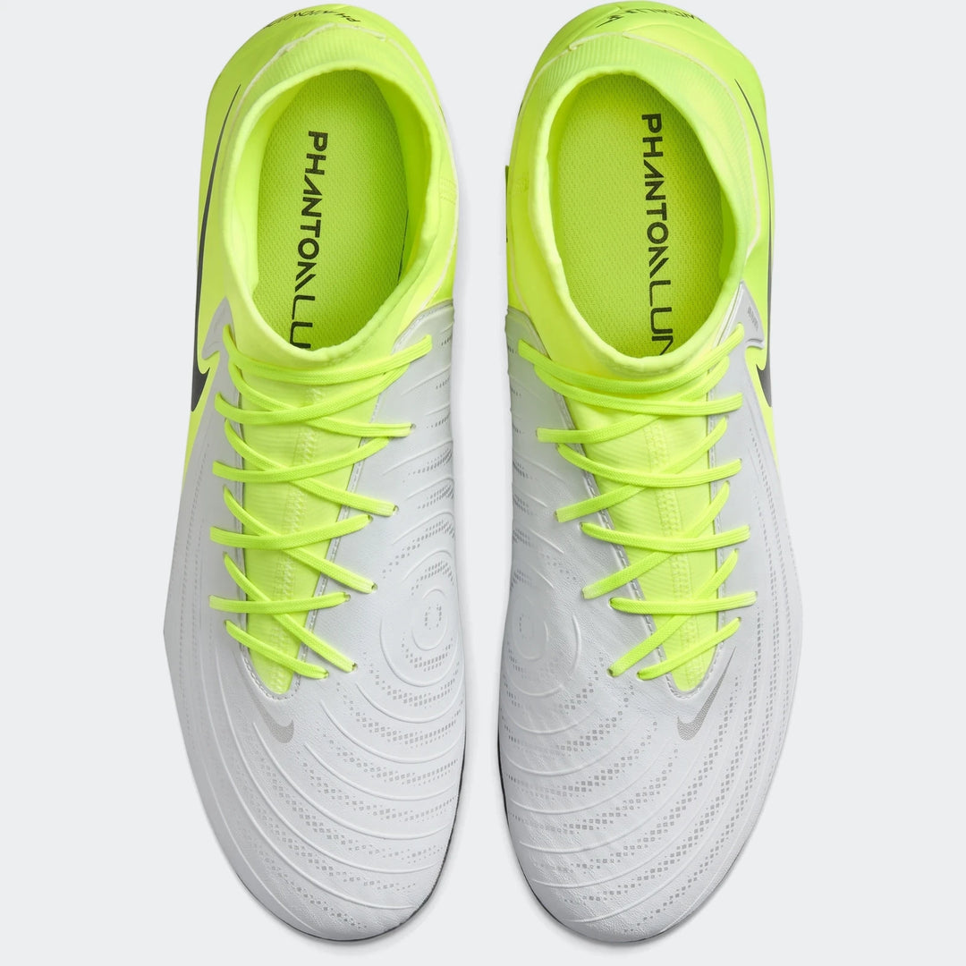 Pair of white and neon yellow Nike Phantom Luna 11 Academy FG/MG soccer boots, shown from an overhead perspective.