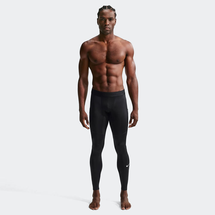 Nike Pro Men's Dri-Fit fitness tights in black, shown full body on a model, showcasing the athletic design and comfortable