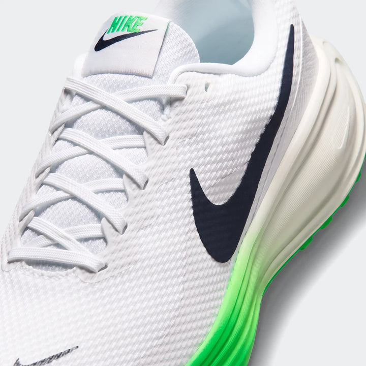 Close-up of a white Nike Revolution 8 Men's Road Running Shoe with black swoosh and green sole accents, featuring white