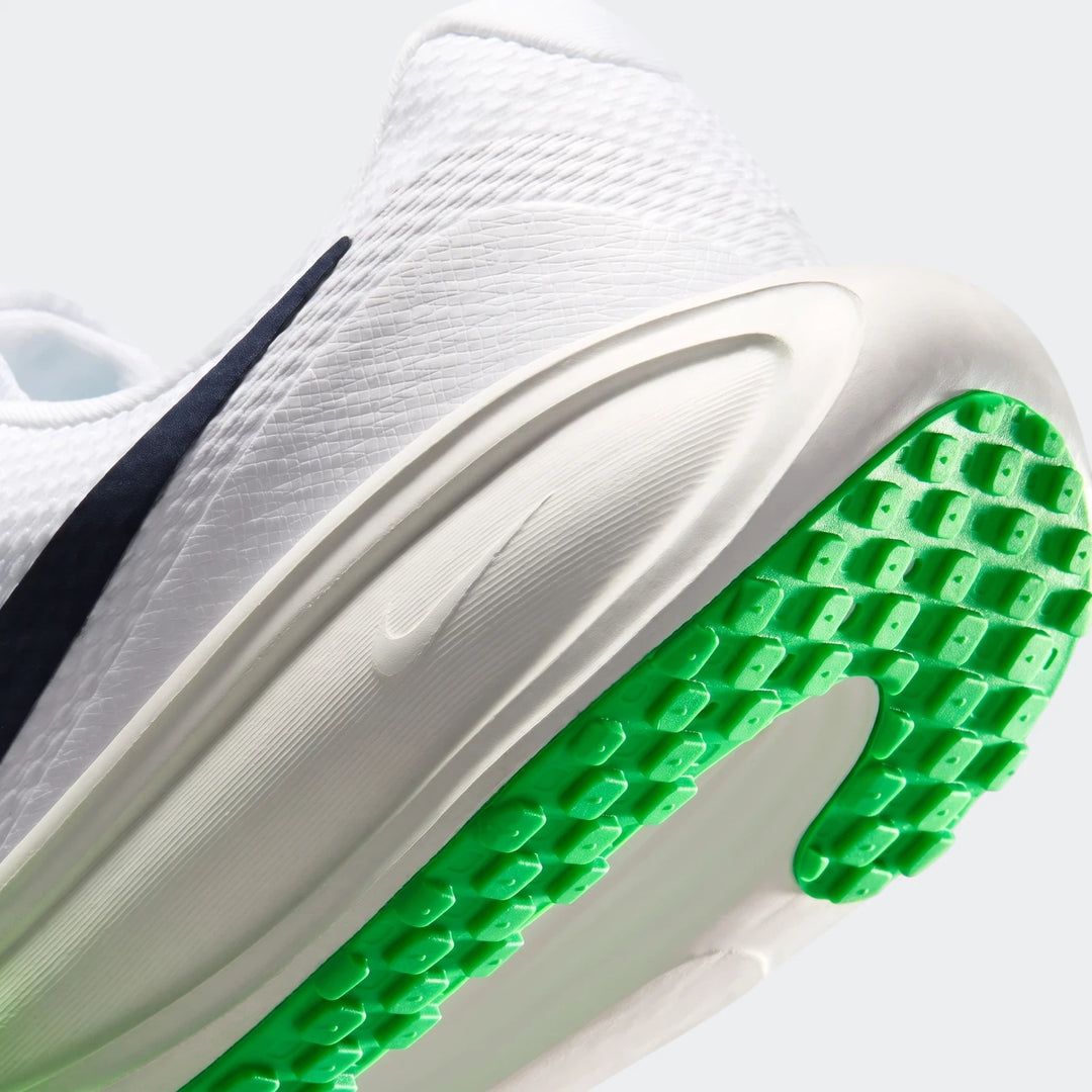 Close-up, angled view of a white Nike Revolution 8 men's road running shoe with a bright green studded sole.