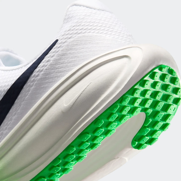 Close-up, angled view of a white Nike Revolution 8 men's road running shoe with a bright green studded sole.
