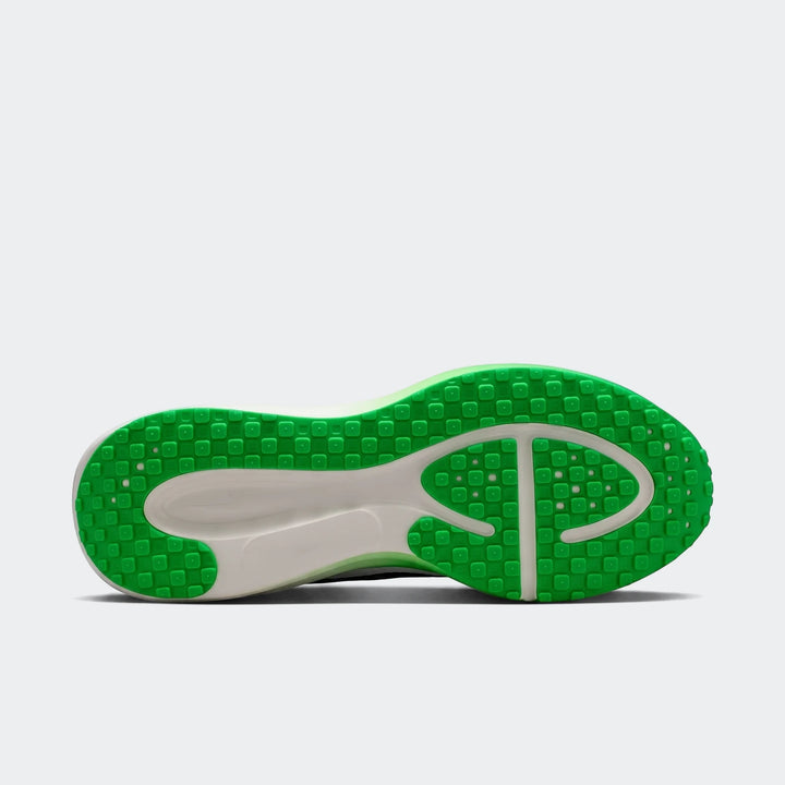 Nike Revolution 8 men's road running shoe, showing the green and white sole from the bottom view.
