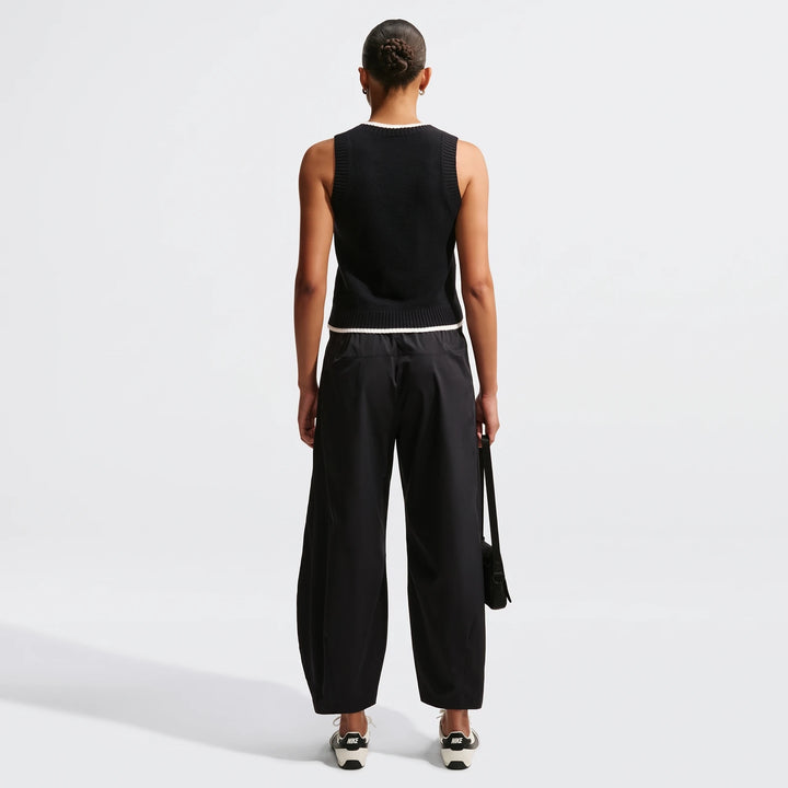 Black Nike Sportswear Chill Knit Women's Loose Sweater Vest and black wide-leg cargo pants with Nike sneakers, full body