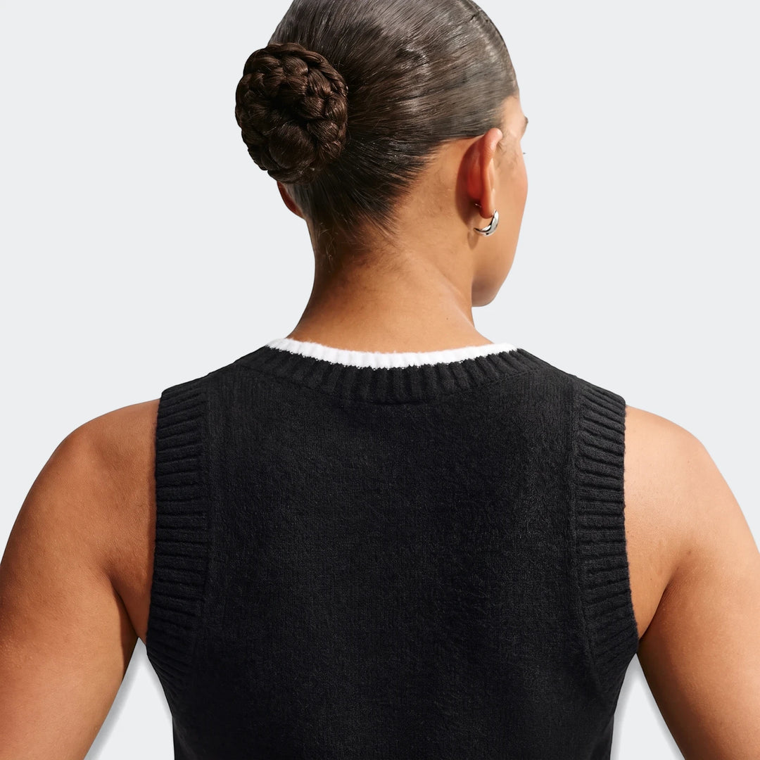 Back view of Nike Sportswear Chill Knit Women's Loose Sweater Vest in black, featuring a white collar and ribbed armholes.