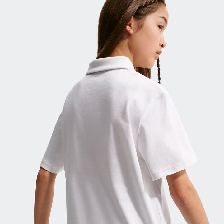 Nike Sportswear Club Big Kids' Knit Short-Sleeve Polo in white, shown on a girl from the back.