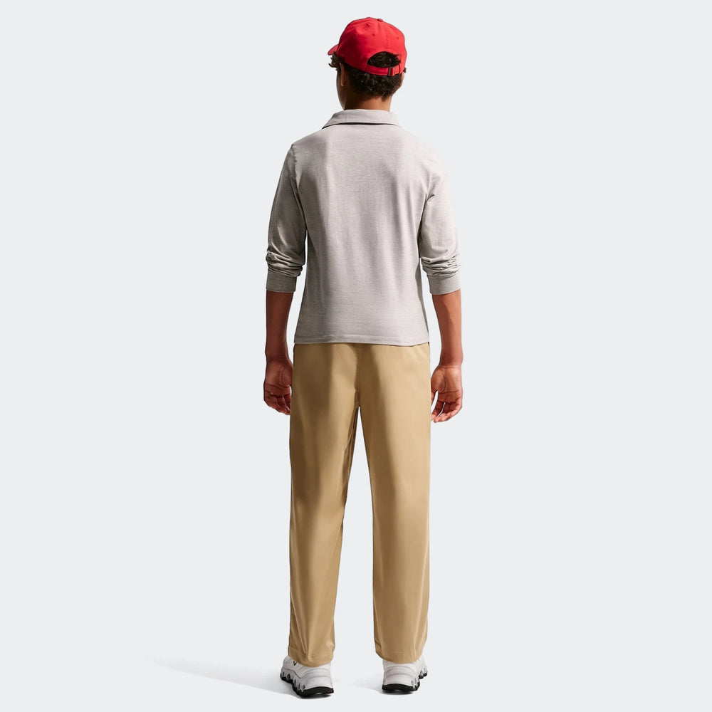 Big kids' Nike Sportswear Club Woven Everyday Pants in khaki, worn by a male model from behind, featuring a comfortable fit.