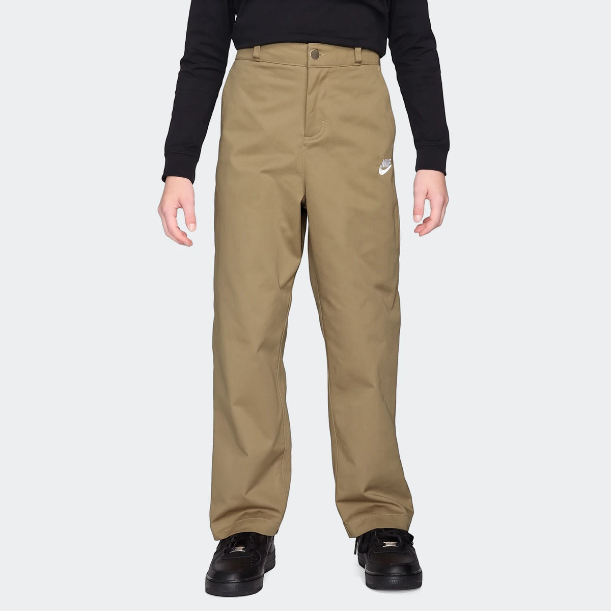 Nike Sportswear Club Big Kids' Woven Everyday Pants in khaki with a white Nike logo, worn by a child with a black