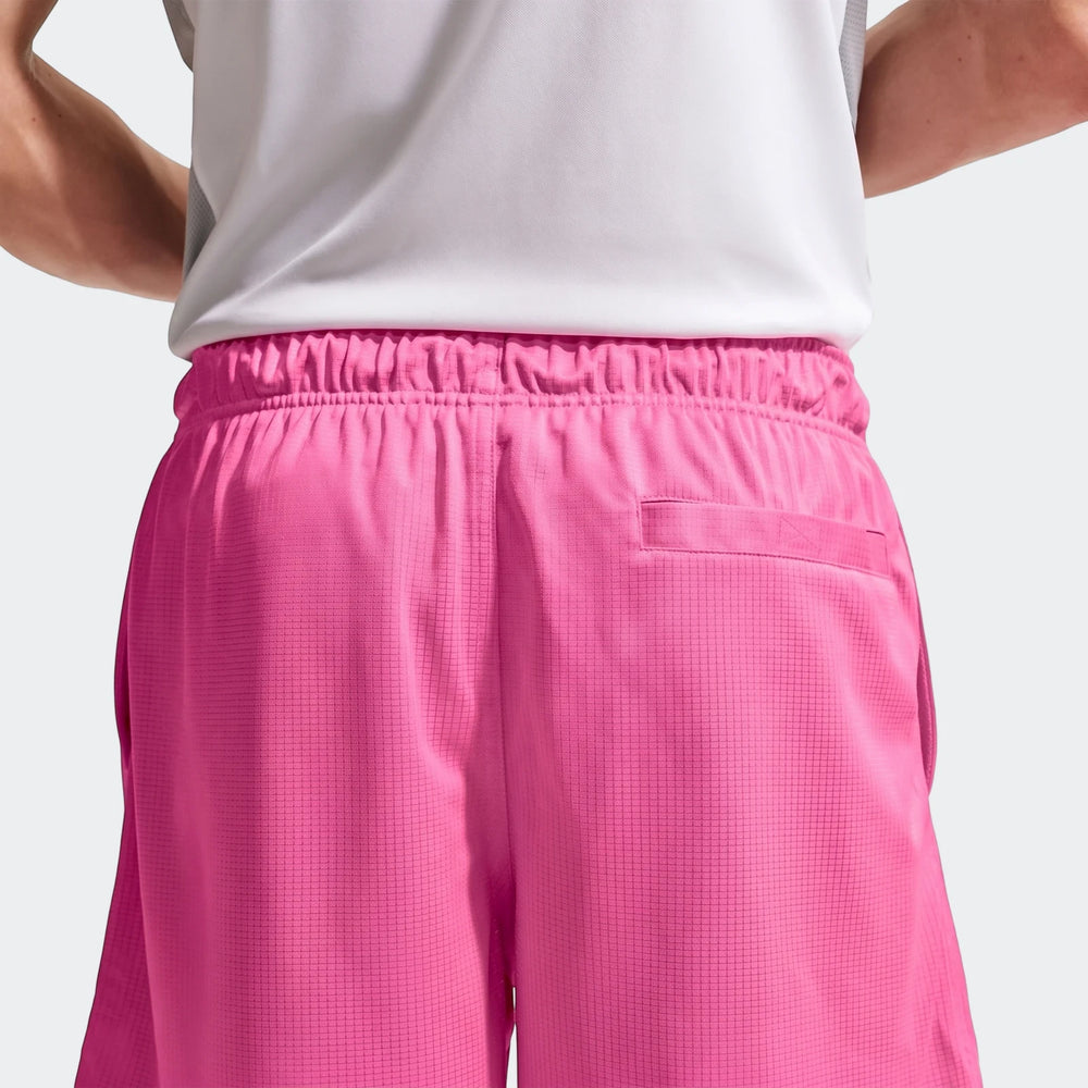 Back view of Nike Sportswear Club Men's Flow Shorts in vibrant pink, featuring an elastic waistband and a back pocket.
