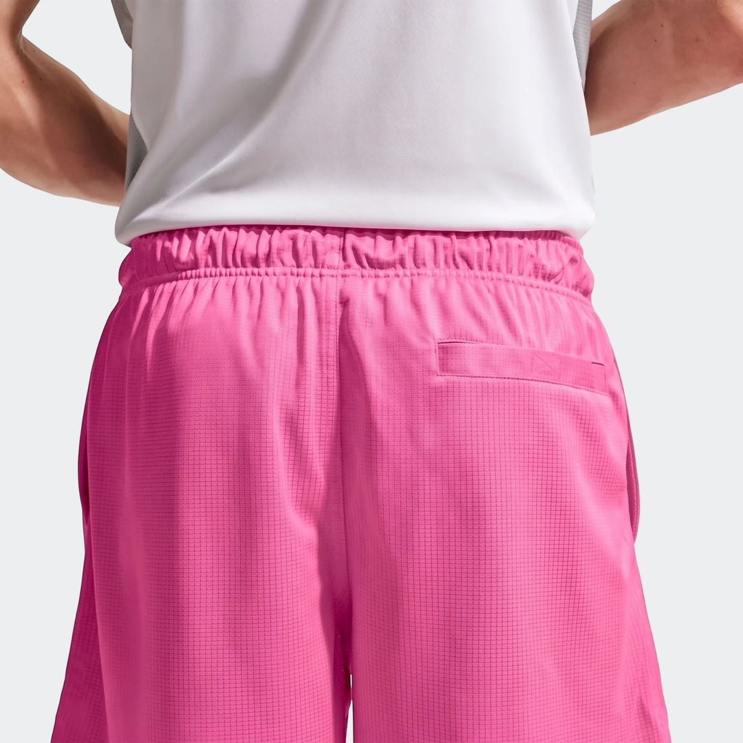 Back view of Nike Sportswear Club Men's Flow Shorts in vibrant pink, featuring an elastic waistband and a back pocket.