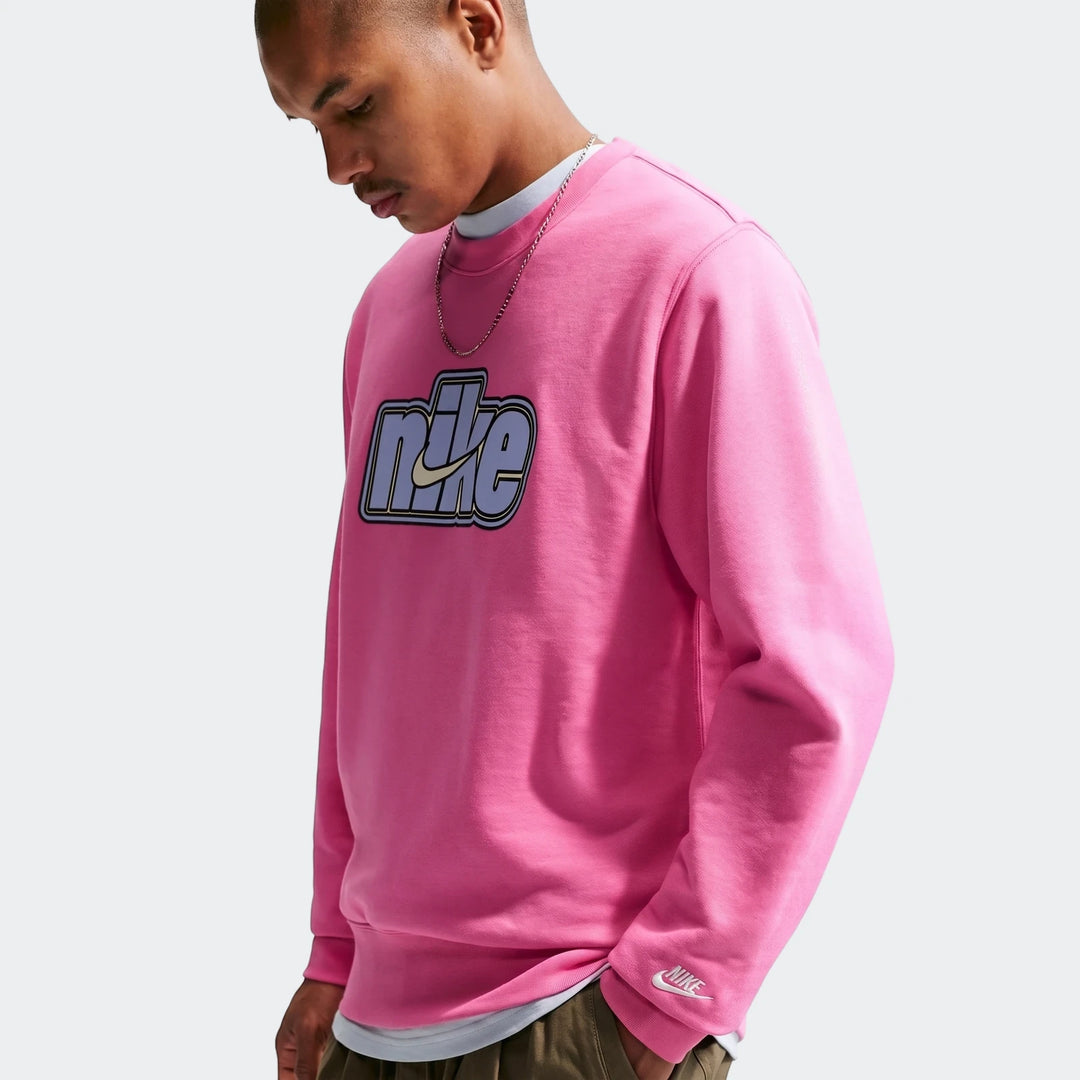 Men's Nike Sportswear Club pink French Terry crew-neck sweatshirt with embroidered logo, worn by a model.