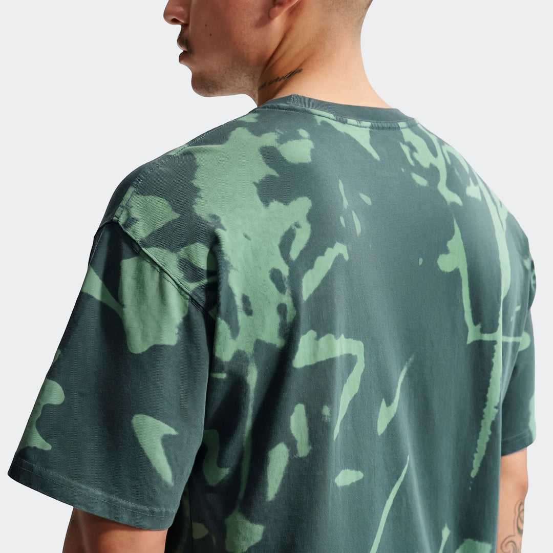 Nike Sportswear men's green tie-dye t-shirt, shown from the back on a male model, featuring an abstract light green pattern
