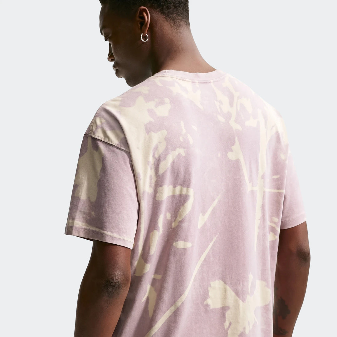 Nike Sportswear pink and off-white tie-dye short-sleeve t-shirt worn by a male model, viewed from the back.