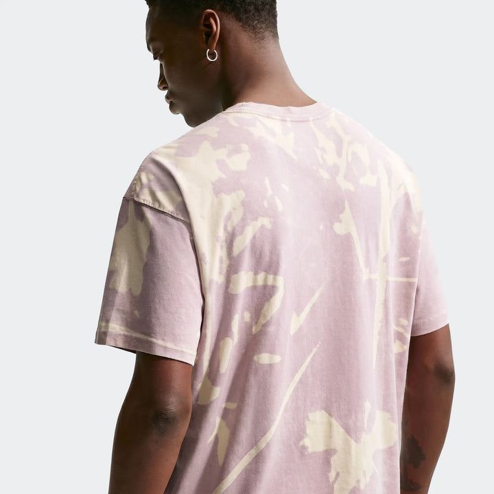 Nike Sportswear pink and off-white tie-dye short-sleeve t-shirt worn by a male model, viewed from the back.