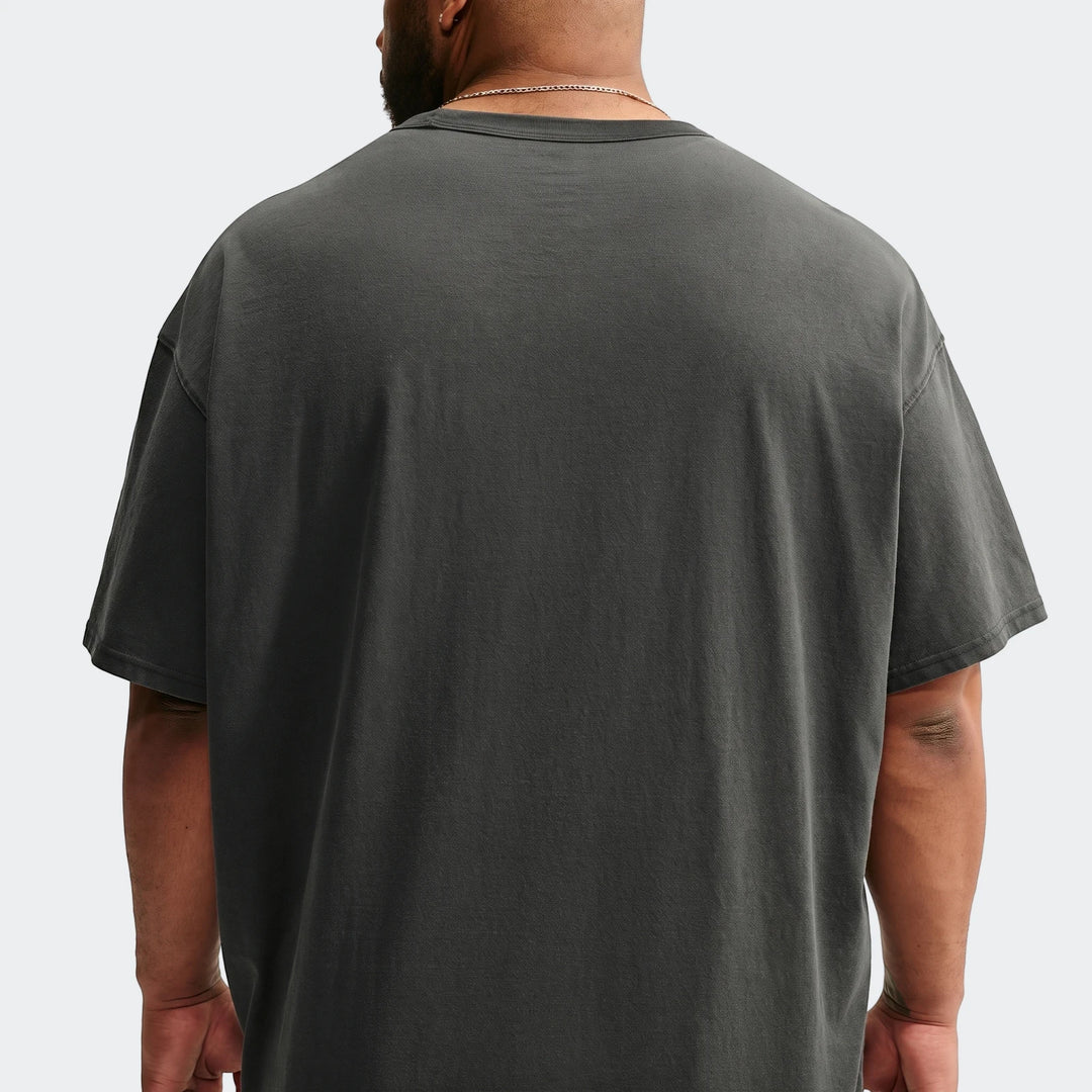 Man wearing a dark grey Nike Sportswear Premium Essentials T-Shirt, photographed from the back, showcasing the garment's fit