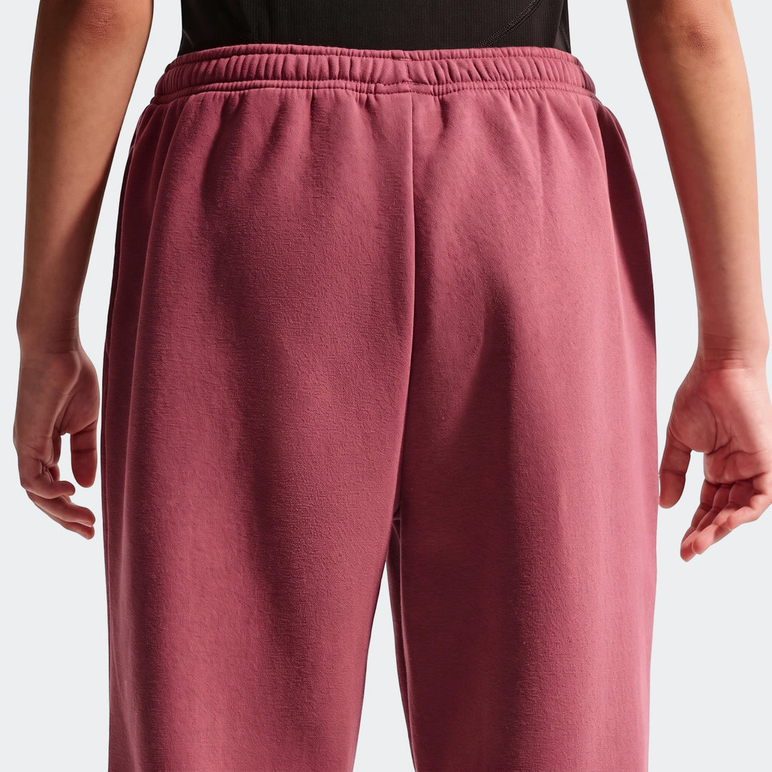 Back view of Nike Sportswear Studio Fleece Girls' Loose Pants in a maroon color, featuring a loose fit and an elastic