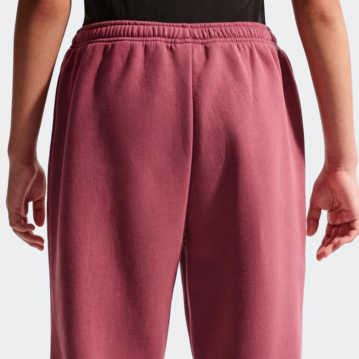Back view of Nike Sportswear Studio Fleece Girls' Loose Pants in a maroon color, featuring a loose fit and an elastic