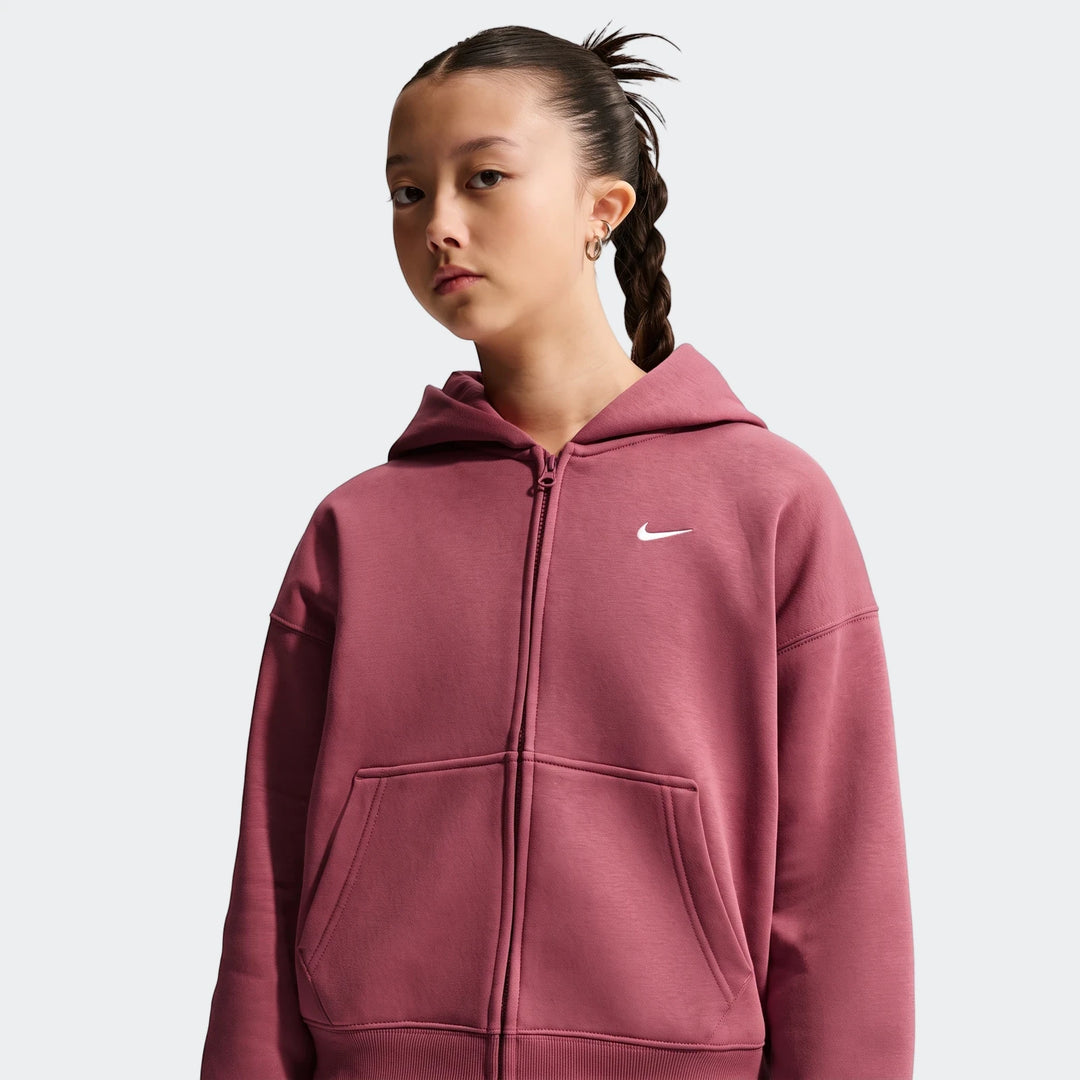 Young girl wearing a Nike Sportswear Studio Fleece oversized full-zip hoodie in dusty rose, chest-up view, with a braided