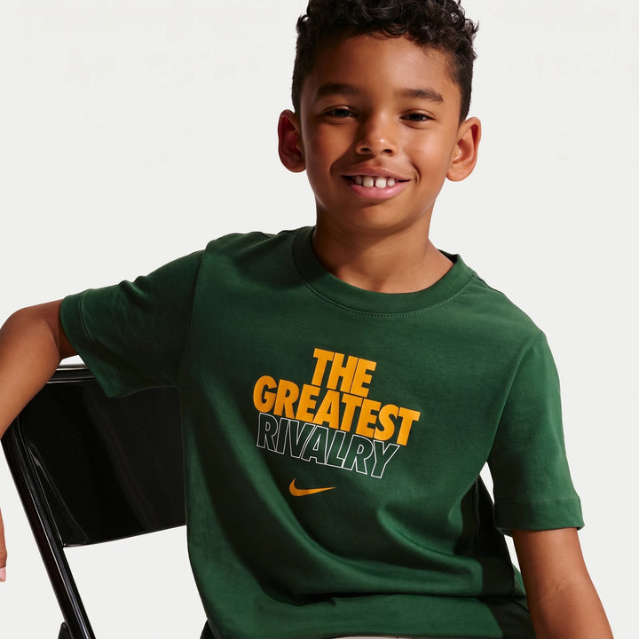 A smiling young boy wears a green 2026 Nike Springboks Rugby's Greatest Rivalry Tour Kids T-Shirt.