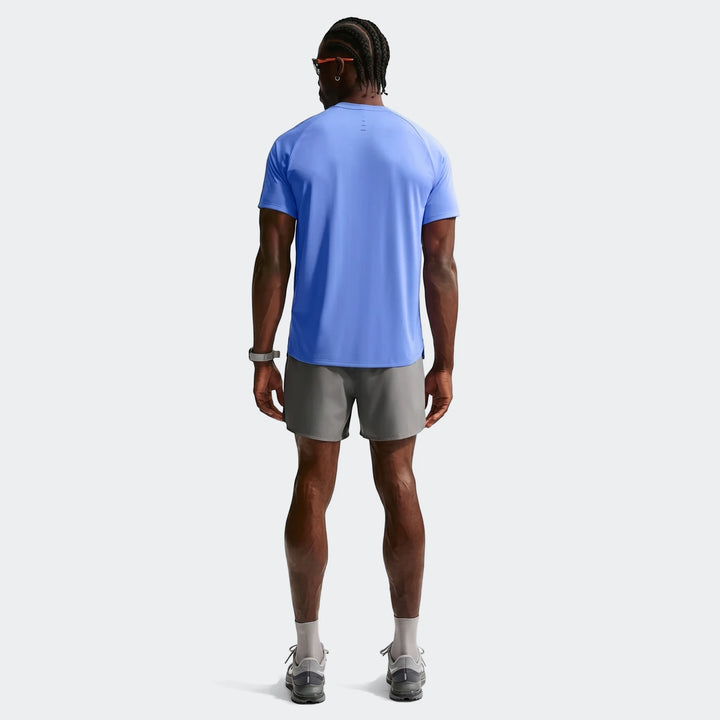 Nike Stride Blue Men's Dri-Fit ADV Short-Sleeve Running Top worn by a man, shown from the back.