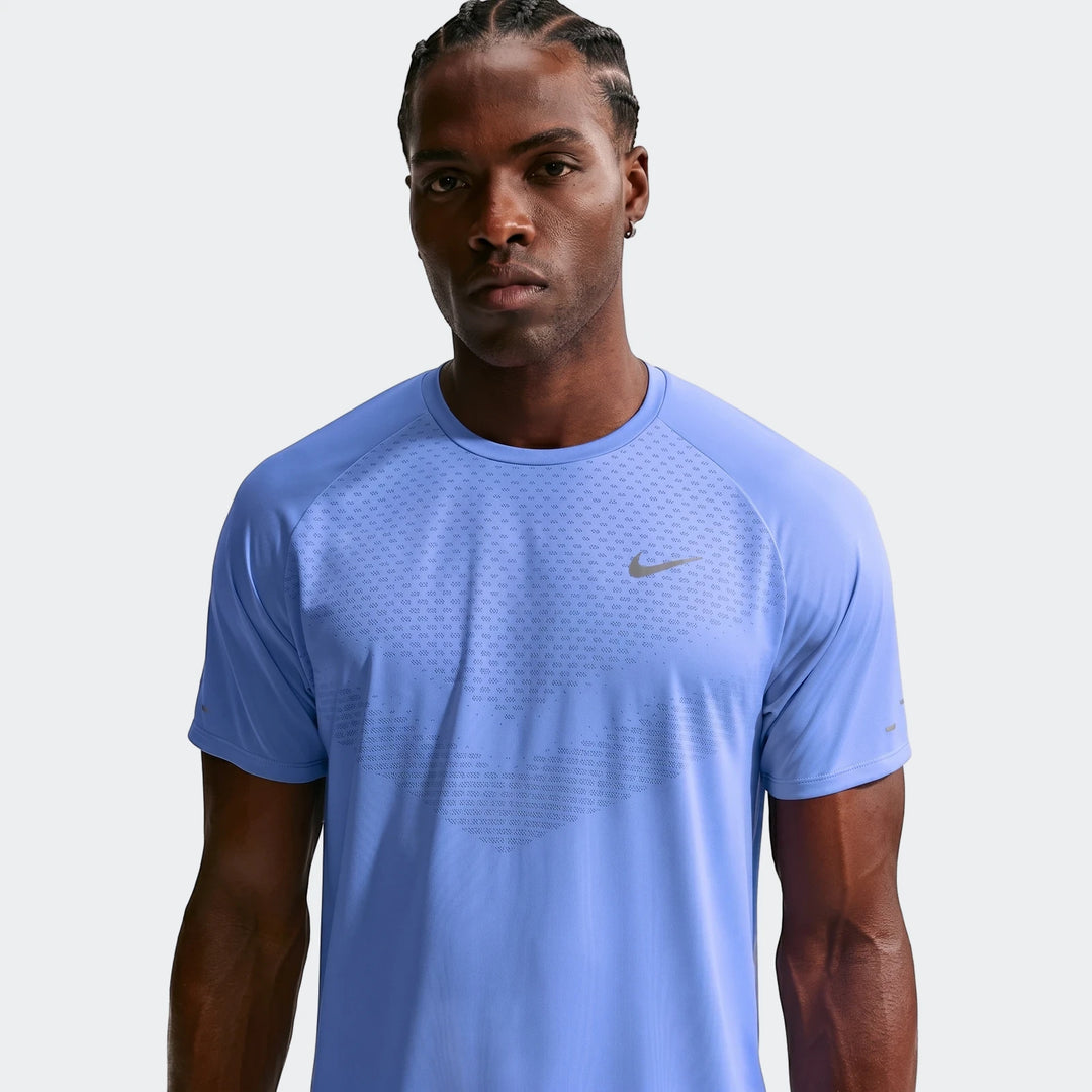 Nike Stride Blue Men's Dri-Fit ADV Short-Sleeve Running Top, front view, modeled by a man with braided hair.