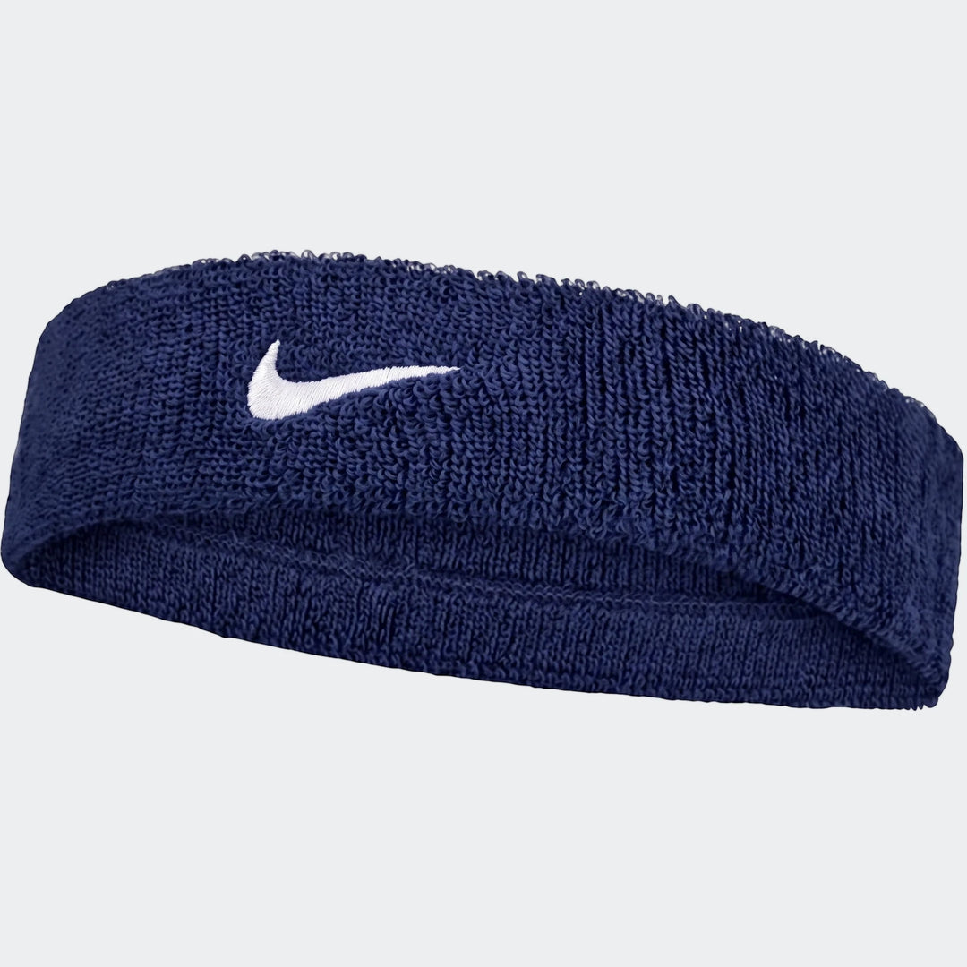 Dark blue terry cloth Nike Swoosh Classic headband for athletic activities, shown angled on a plain background.