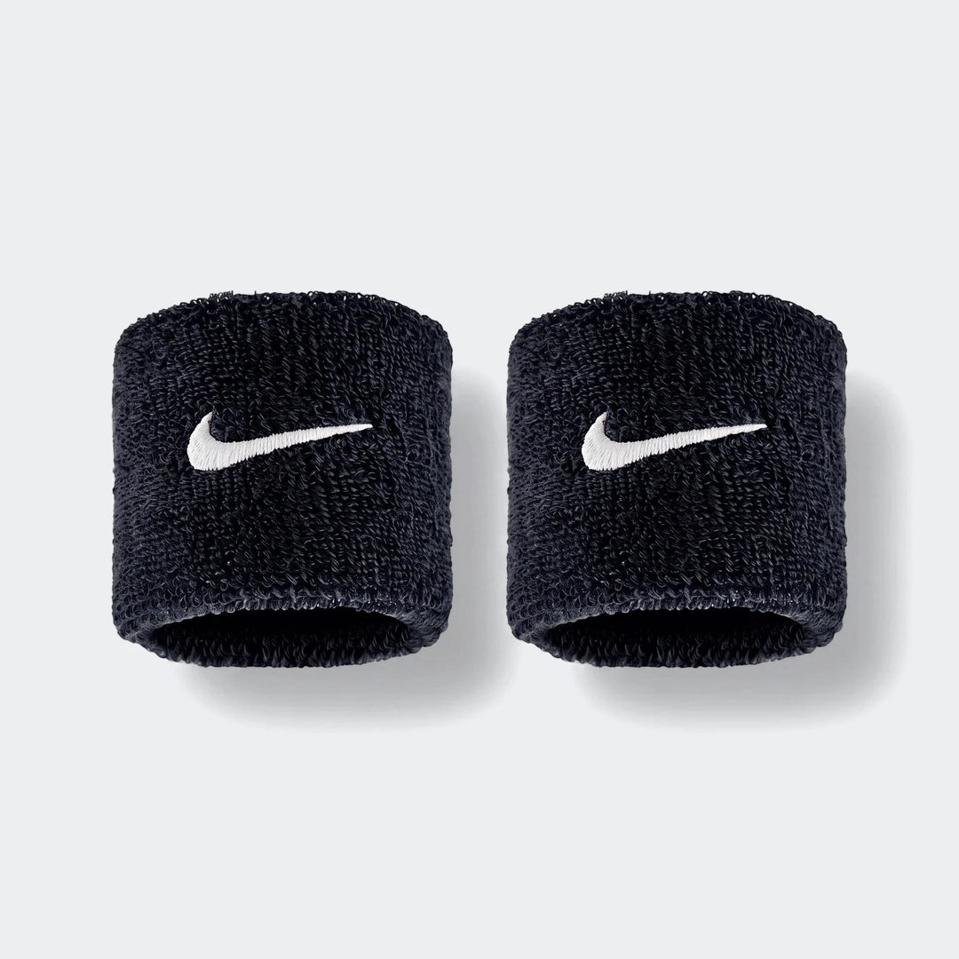 A pair of black Nike Swoosh Classic D terry cloth wristbands with white embroidered logos, shown side by side.