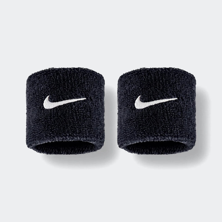 A pair of black Nike Swoosh Classic D terry cloth wristbands with white embroidered logos, shown side by side.