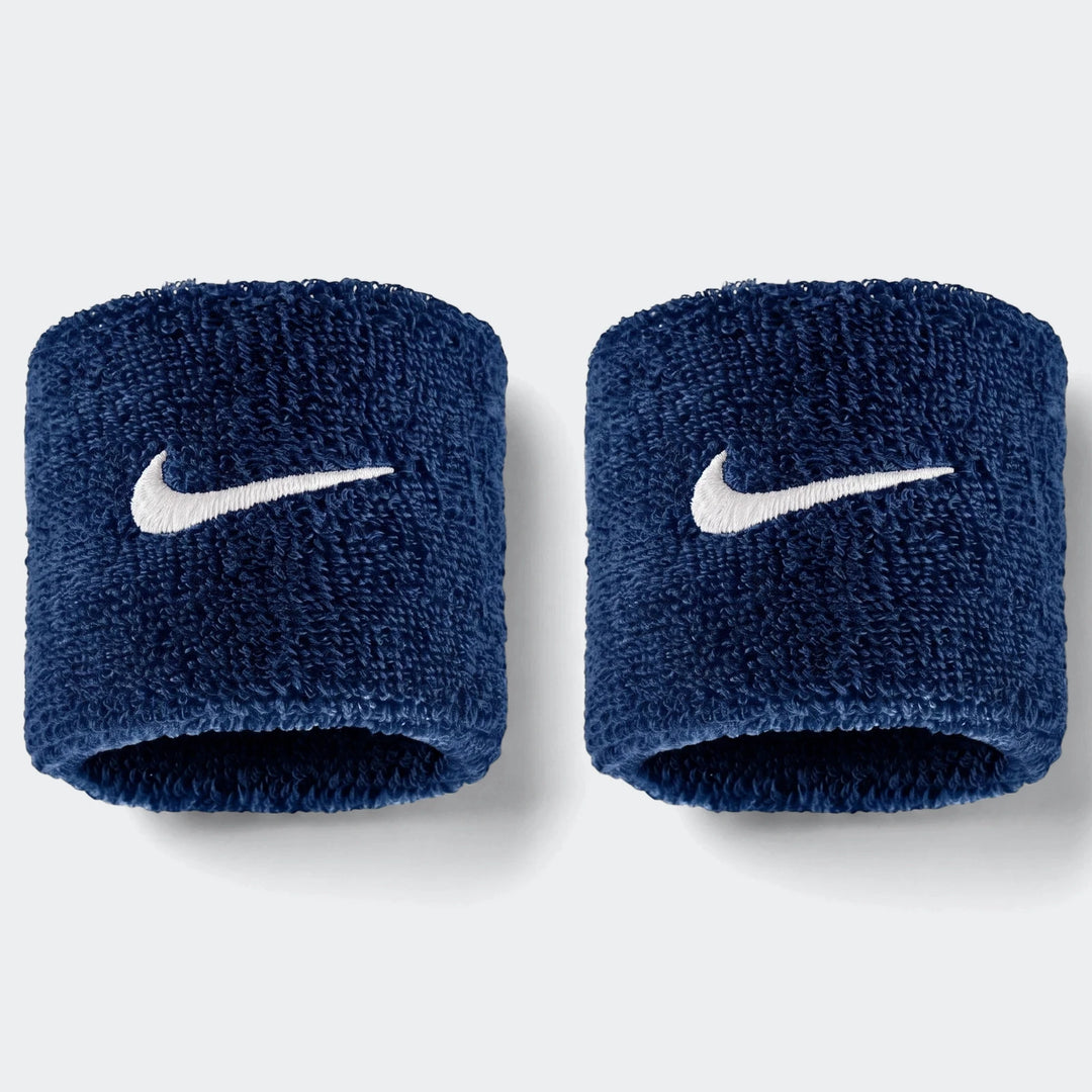 Pair of Nike Swoosh Classic navy blue terry cloth wristbands shown side by side on a white background, ideal for sports.