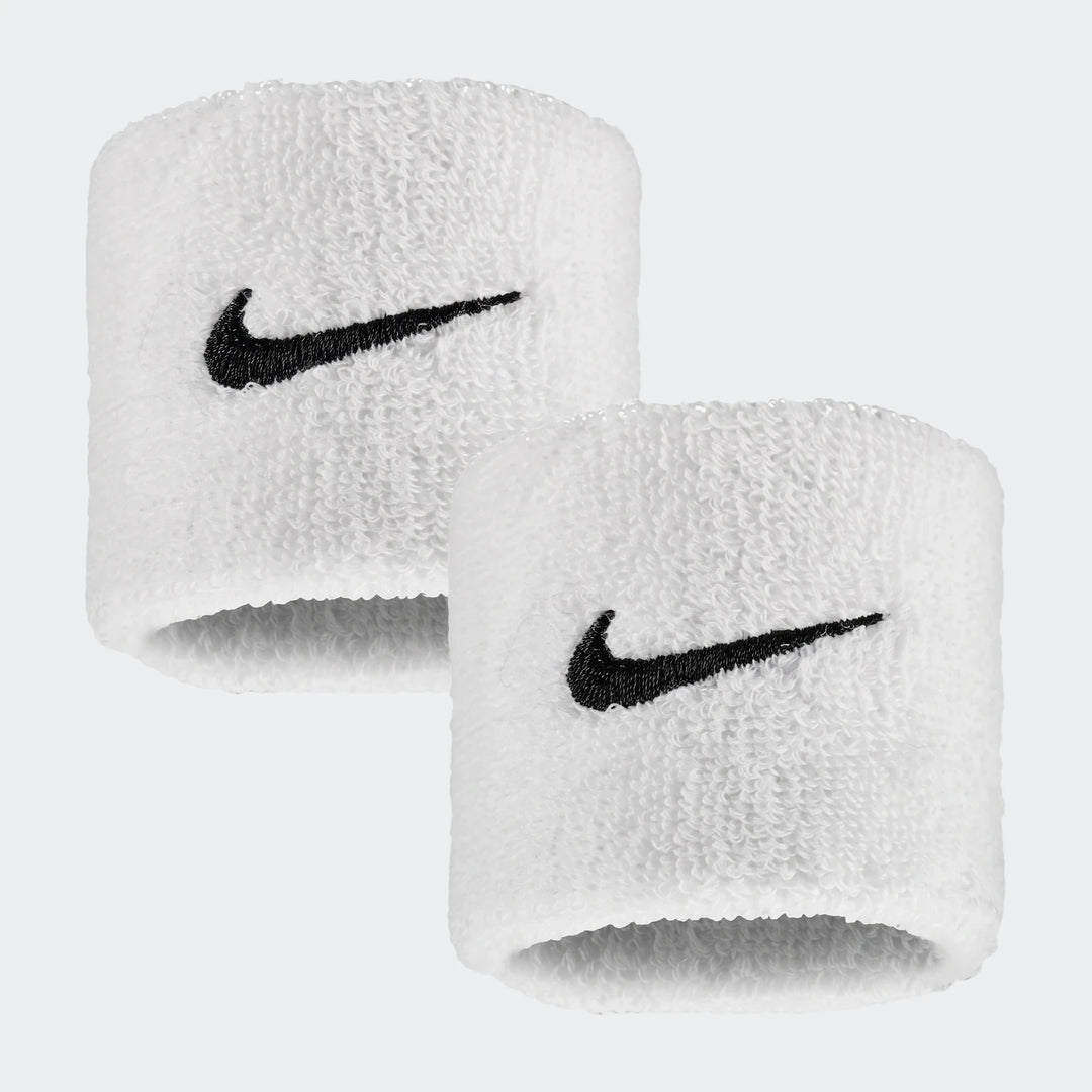 A pair of white terry cloth Nike Swoosh Classic wristbands with embroidered black logos, shown slightly offset.