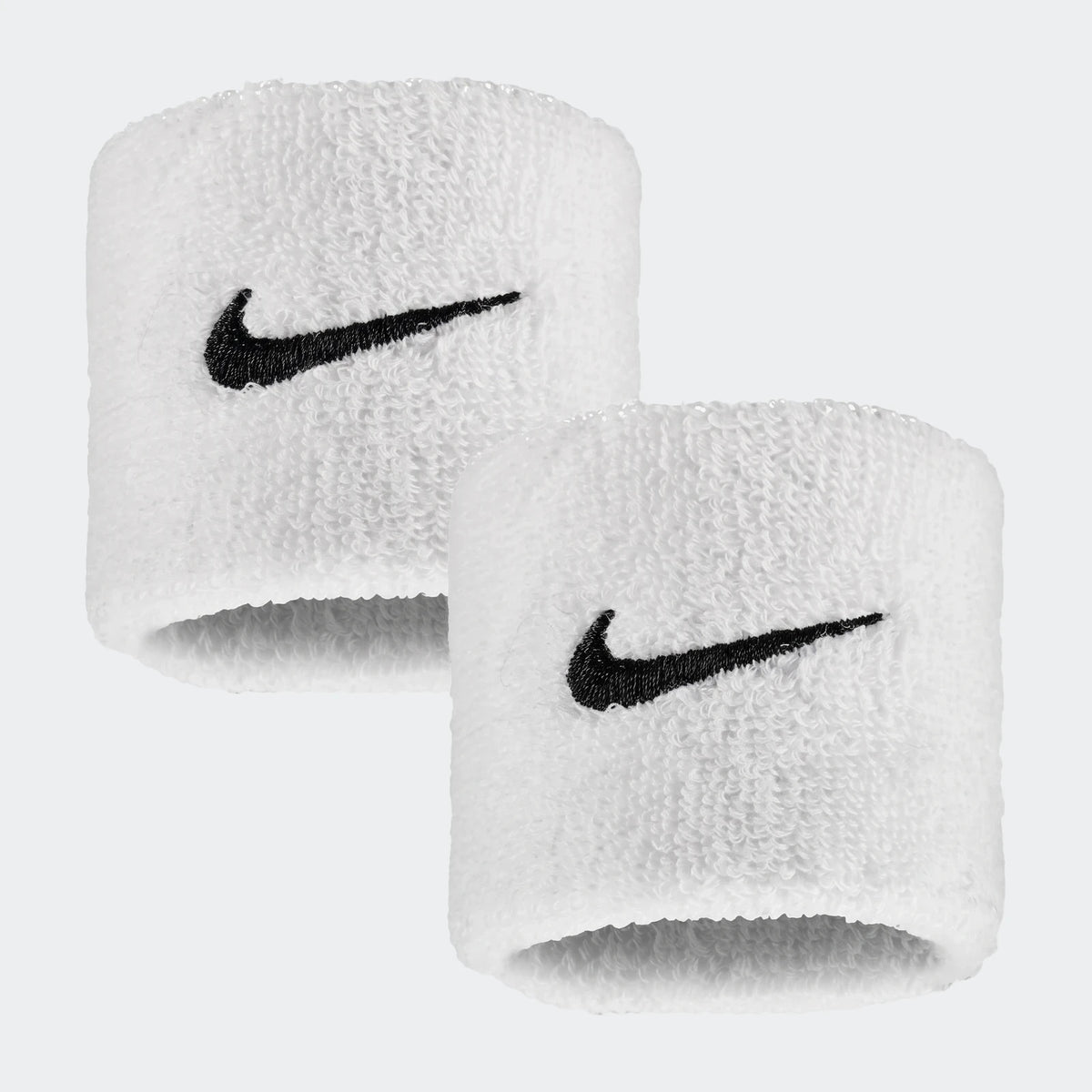 A pair of white terry cloth Nike Swoosh Classic wristbands with embroidered black logos, shown slightly offset.
